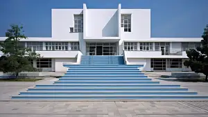 Walter Gropius, school with Bauhaus design and clean lines, educational and inspiring, captured by Mark Steinmetz. White, blue, and concrete, intricate, ornate. –ar 16:9 –c 2 –s 90